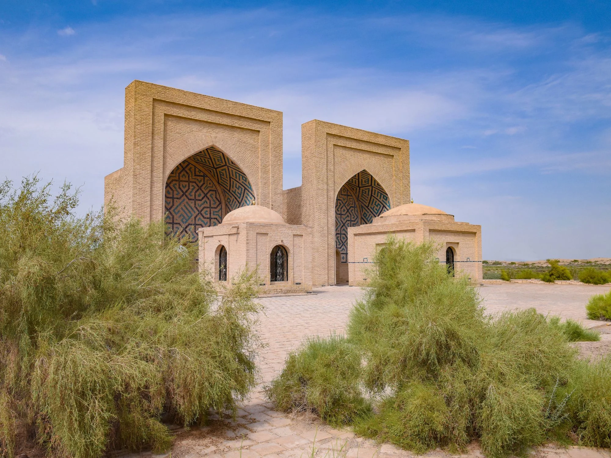 Twin brick portals with turquoise geometric tilework at the Ancient Merv archaeological site
