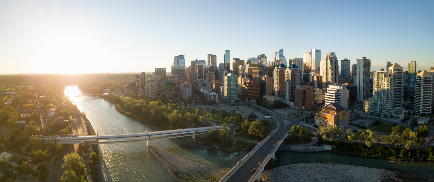 Calgary skyline with tall buildings and river in the foreground