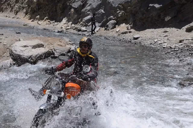 Shankar Nath crossing river on bike