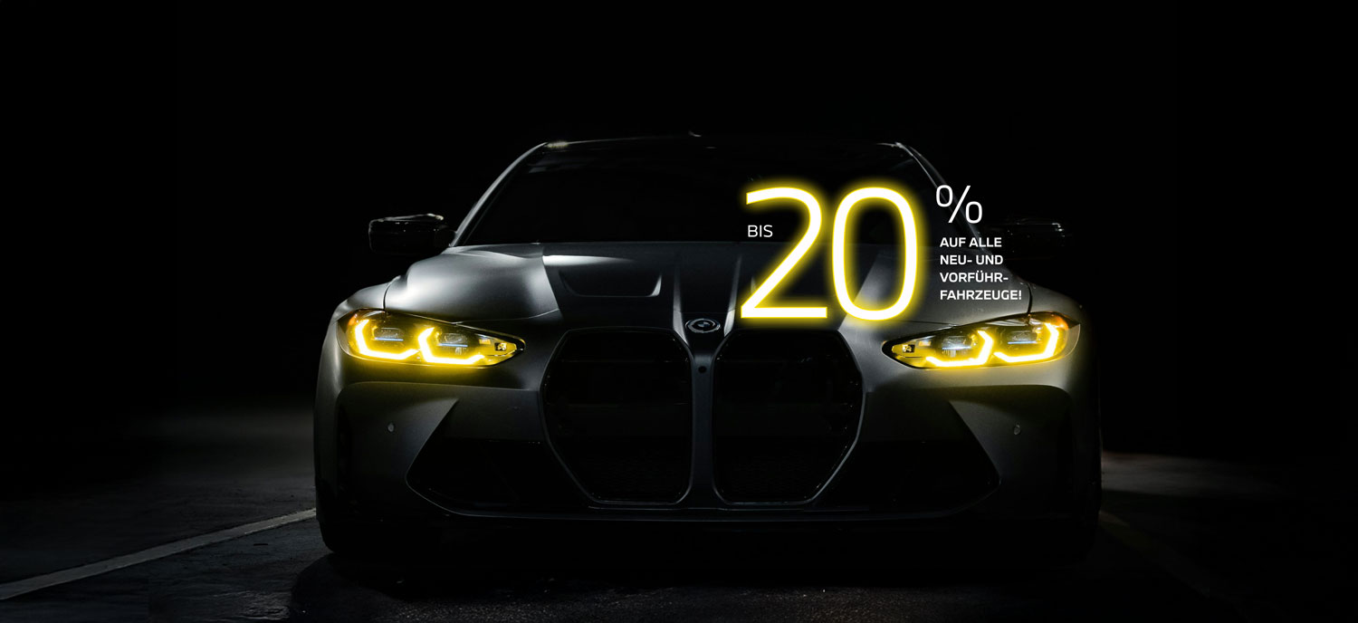 Frontansicht eines BMW mit gelb leuchtenden Scheinwerfern vor schwarzem Hintergrund mit Hinweis auf Black Weeks Rabattaktion – BMW Wolter & Steiner in Neubrandenburg, Waren und Prenzlau