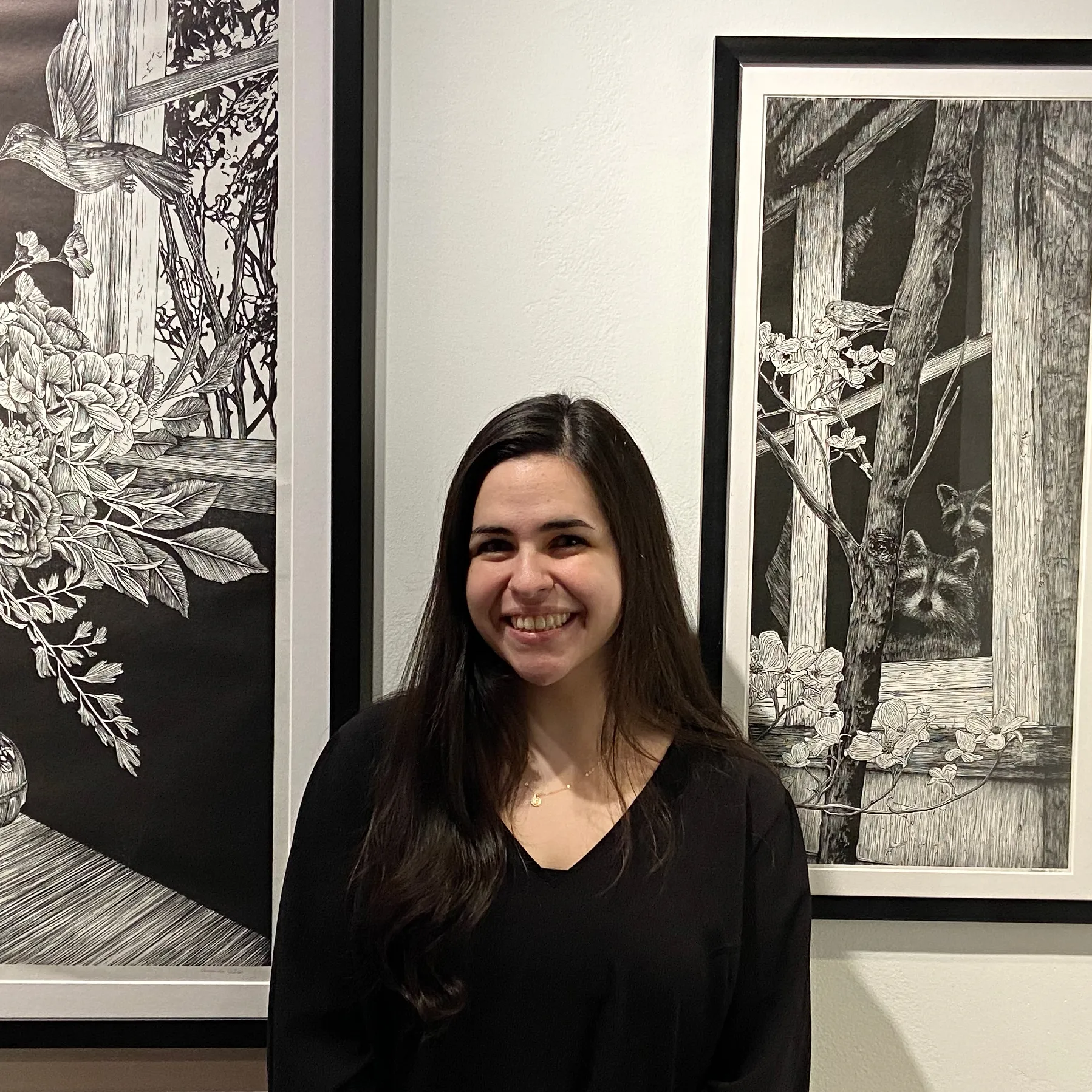 A photo of artist Amanda DiLisi in front of her artwork.