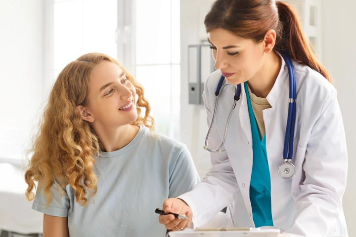 Young woman reviewing health options with doctor
