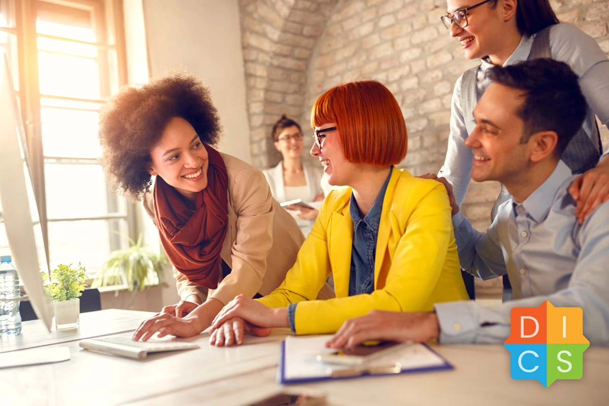 Group of casually dressed young professionals enjoying a discussion in a sunlit room