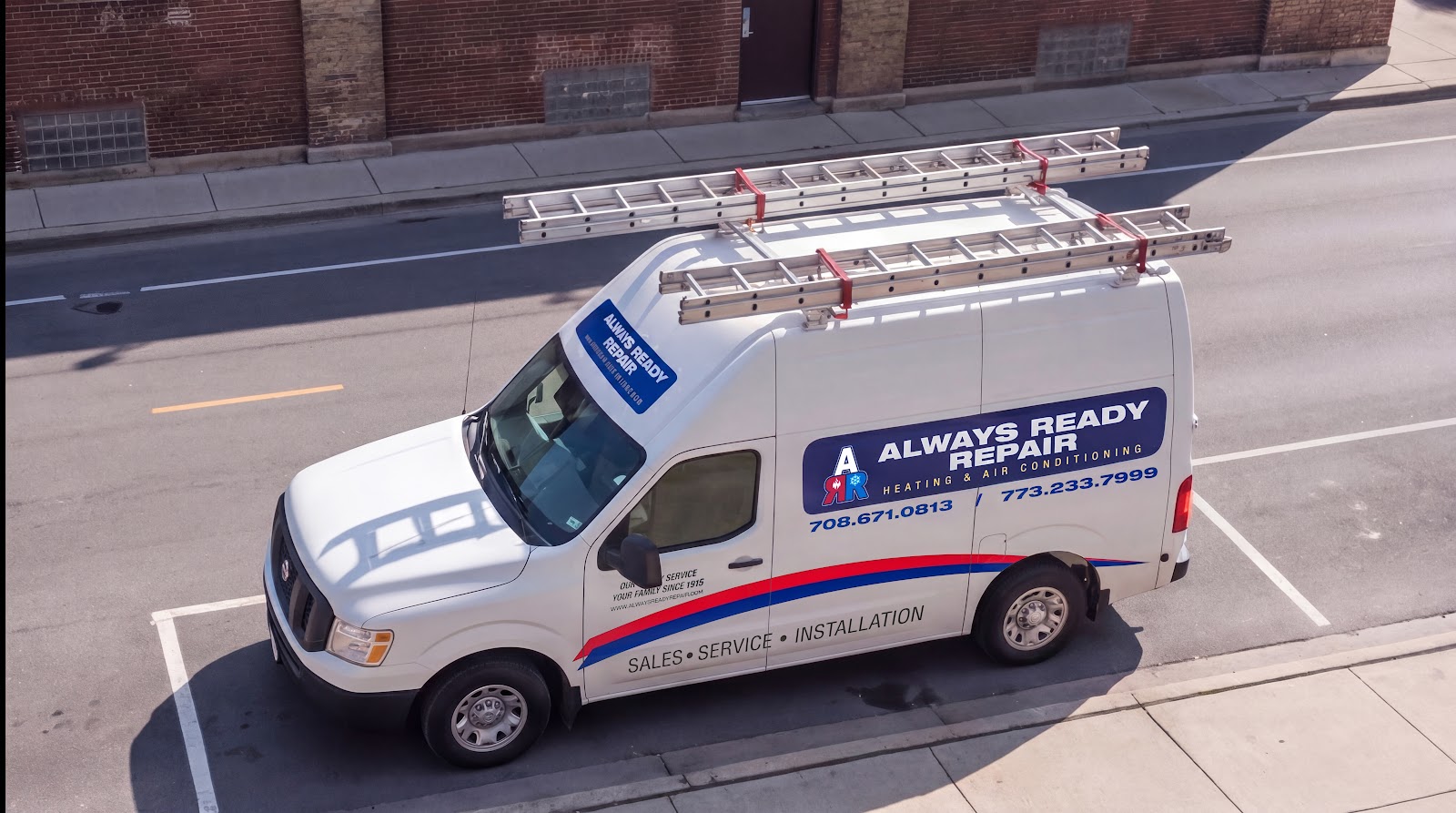 Always Ready Repair service van with ladders parked on a Chicago street