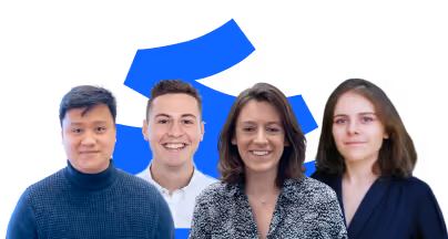 Group portrait of four smiling young adults standing in front of a blue abstract design.