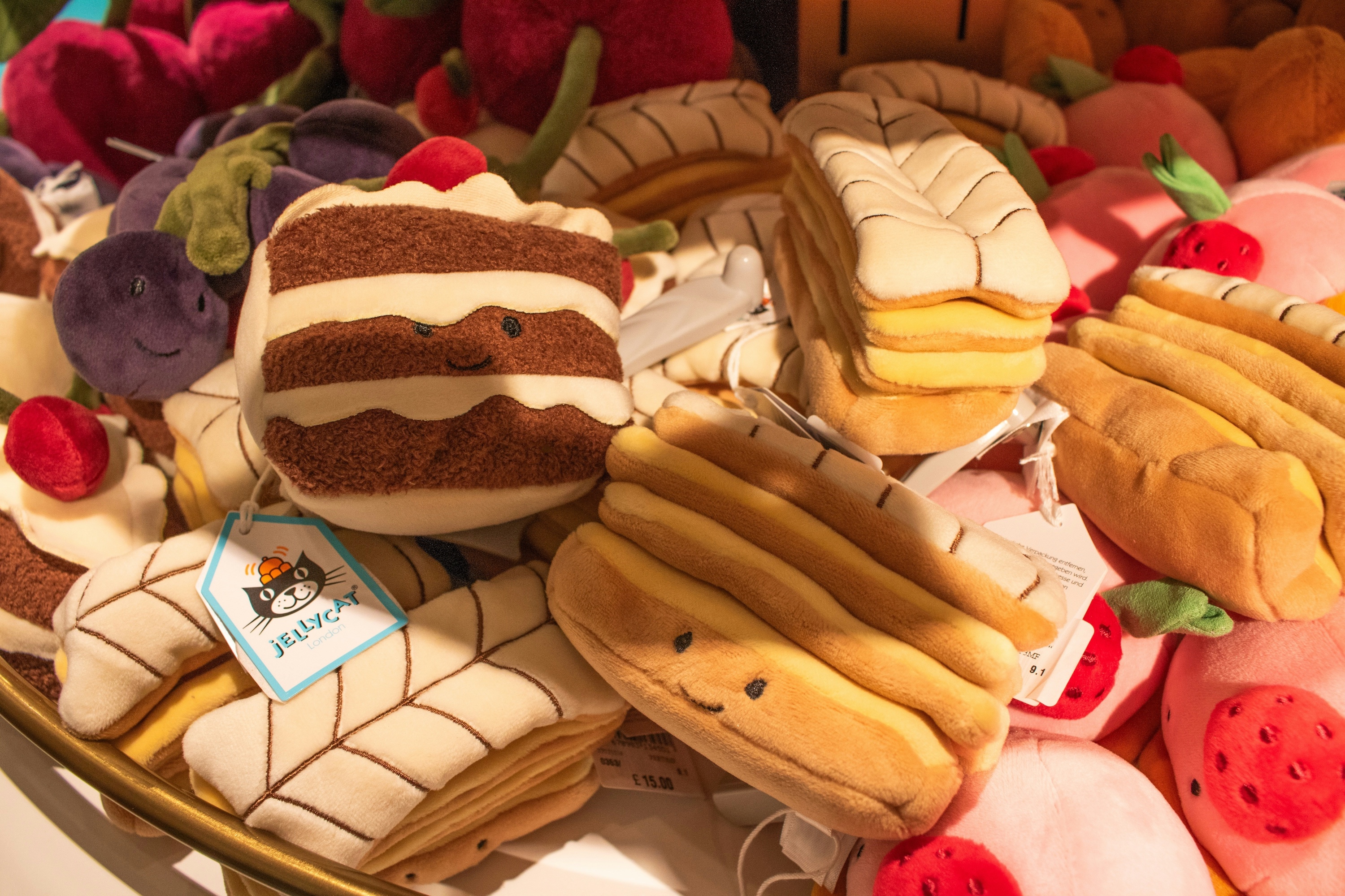 A basket of jellycat dolls in different pastry themes