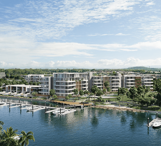 Modern waterfront residential buildings with boats docked along a marina under a partly cloudy sky.