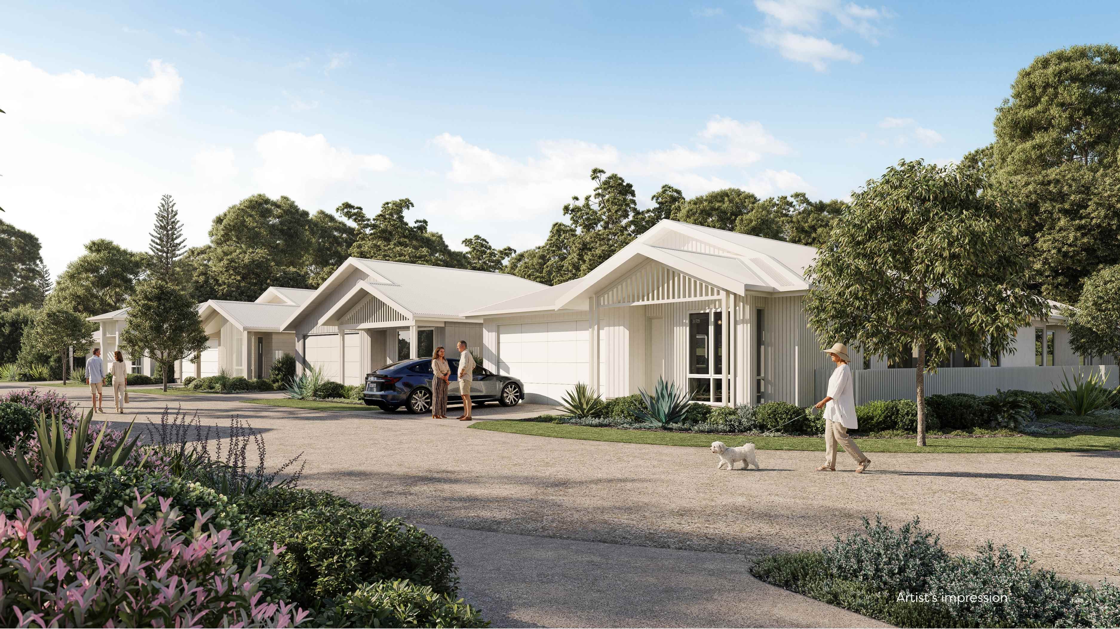 Modern single-story houses with metal roofs along a tree-lined street under a clear blue sky.