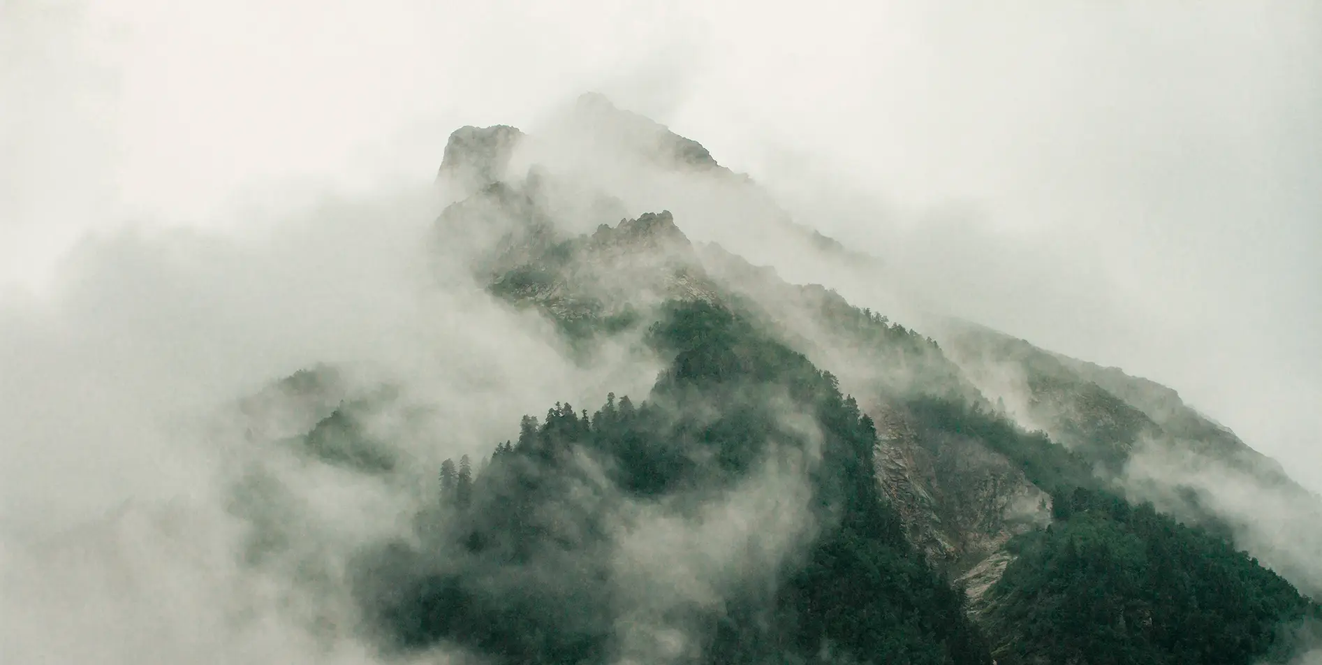 Swiss alpine peak shrouded in mist, an exclusive and poetic interlude offered by SNUUG.