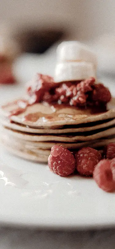 Indulgent pancakes with red berries, 4-star breakfast service in the heart of nature.