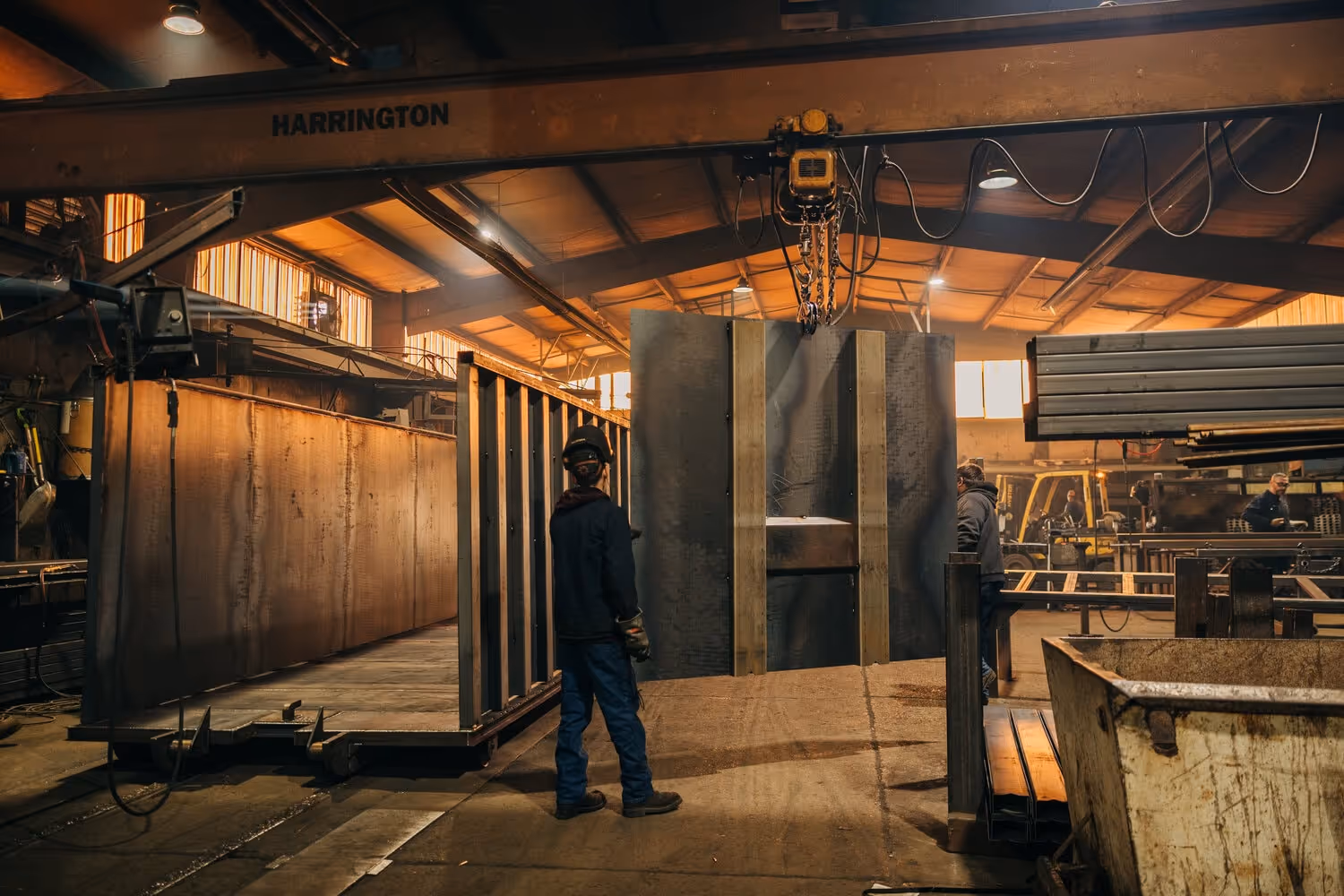 Welders move a container wall into place at Stone Valley Container
