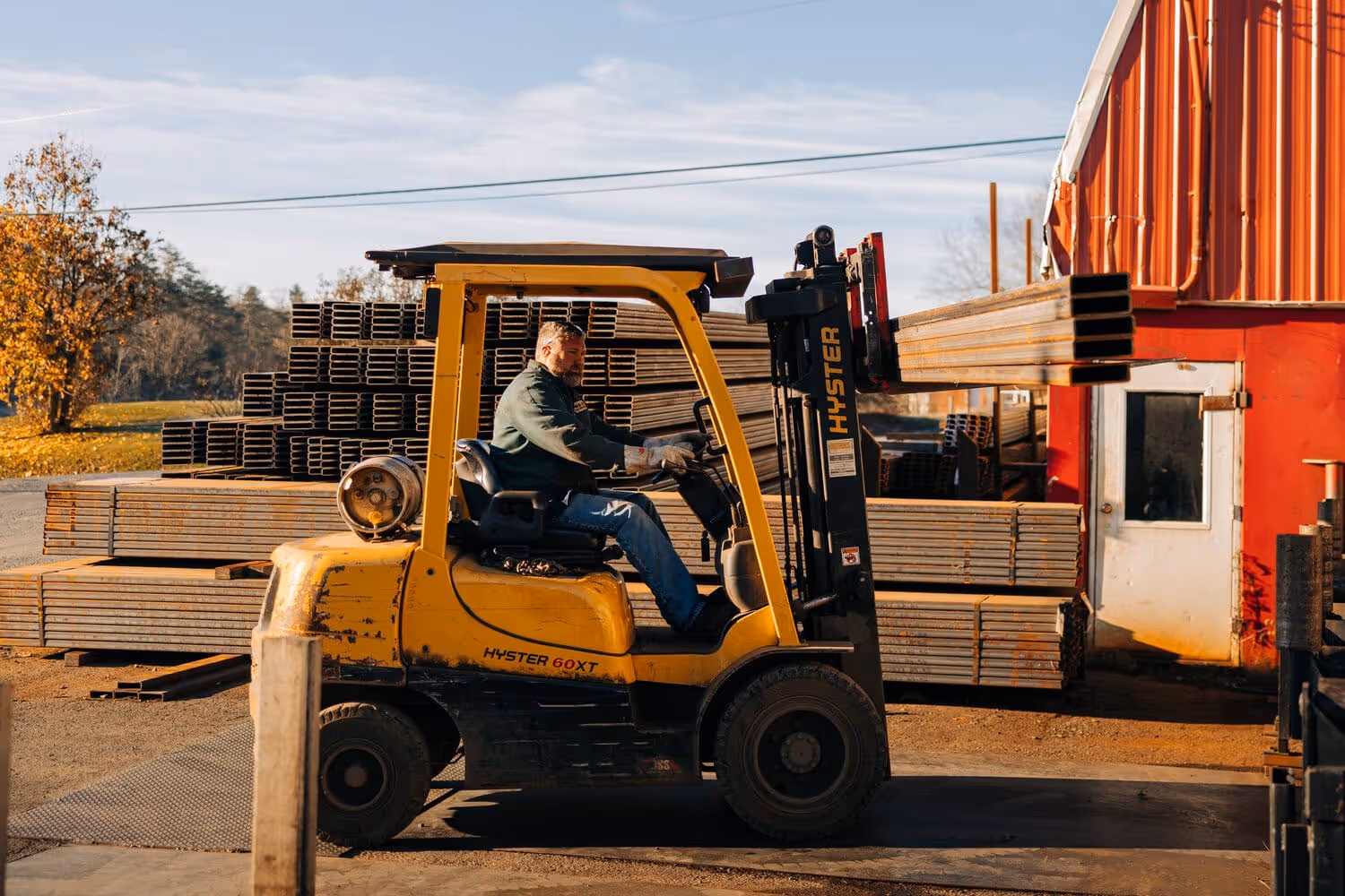 Stone Valley Container employee driving a yellow forklift