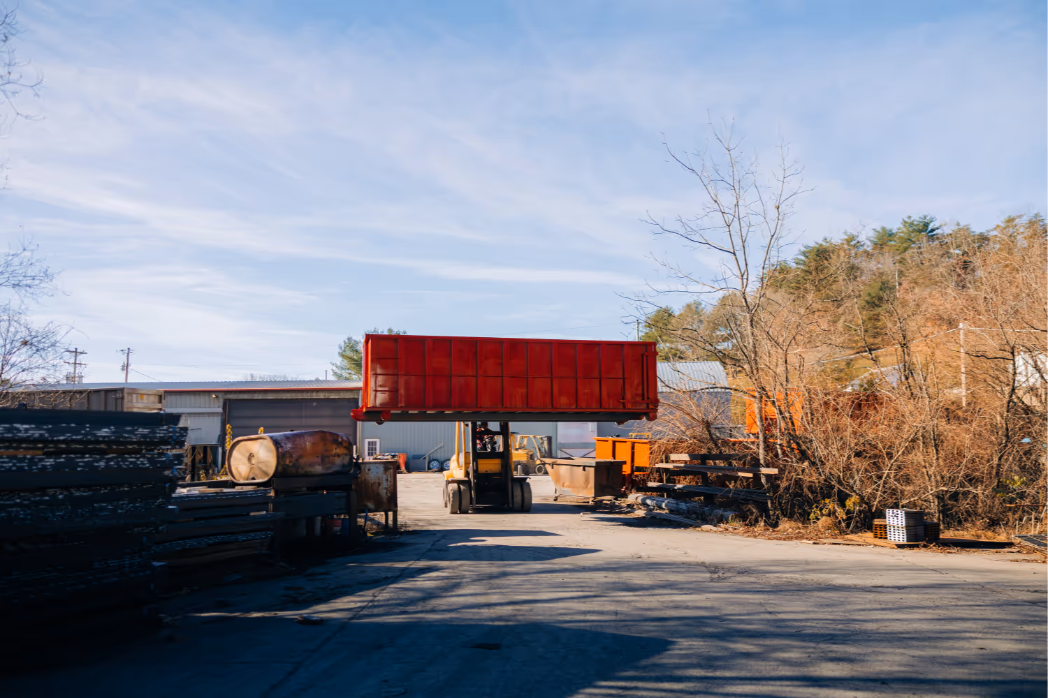 Stone Valley Container transporting a roll-off container with forklift
