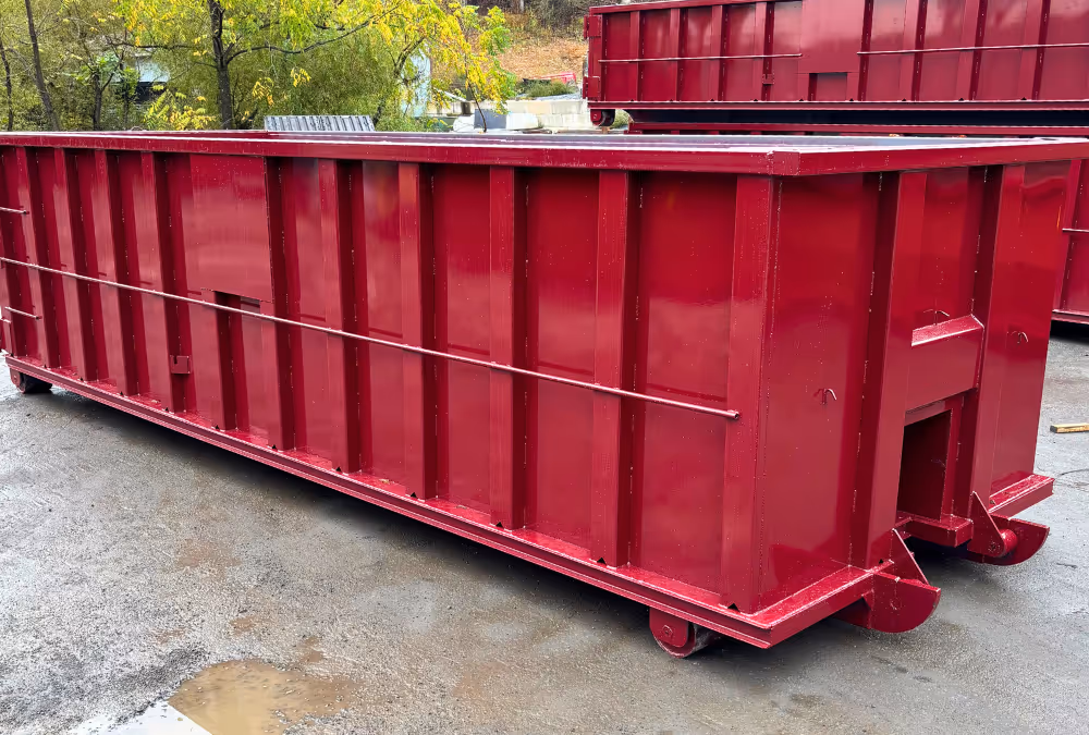 Burgundy colored roll off container