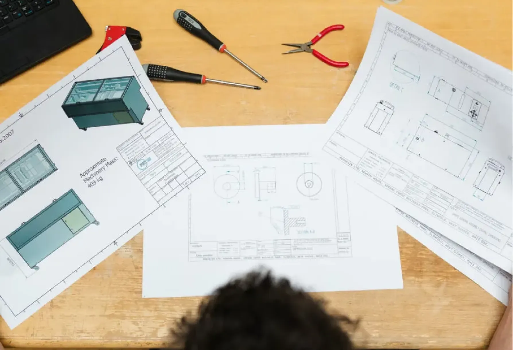 A table topped with paper and tools on top of it