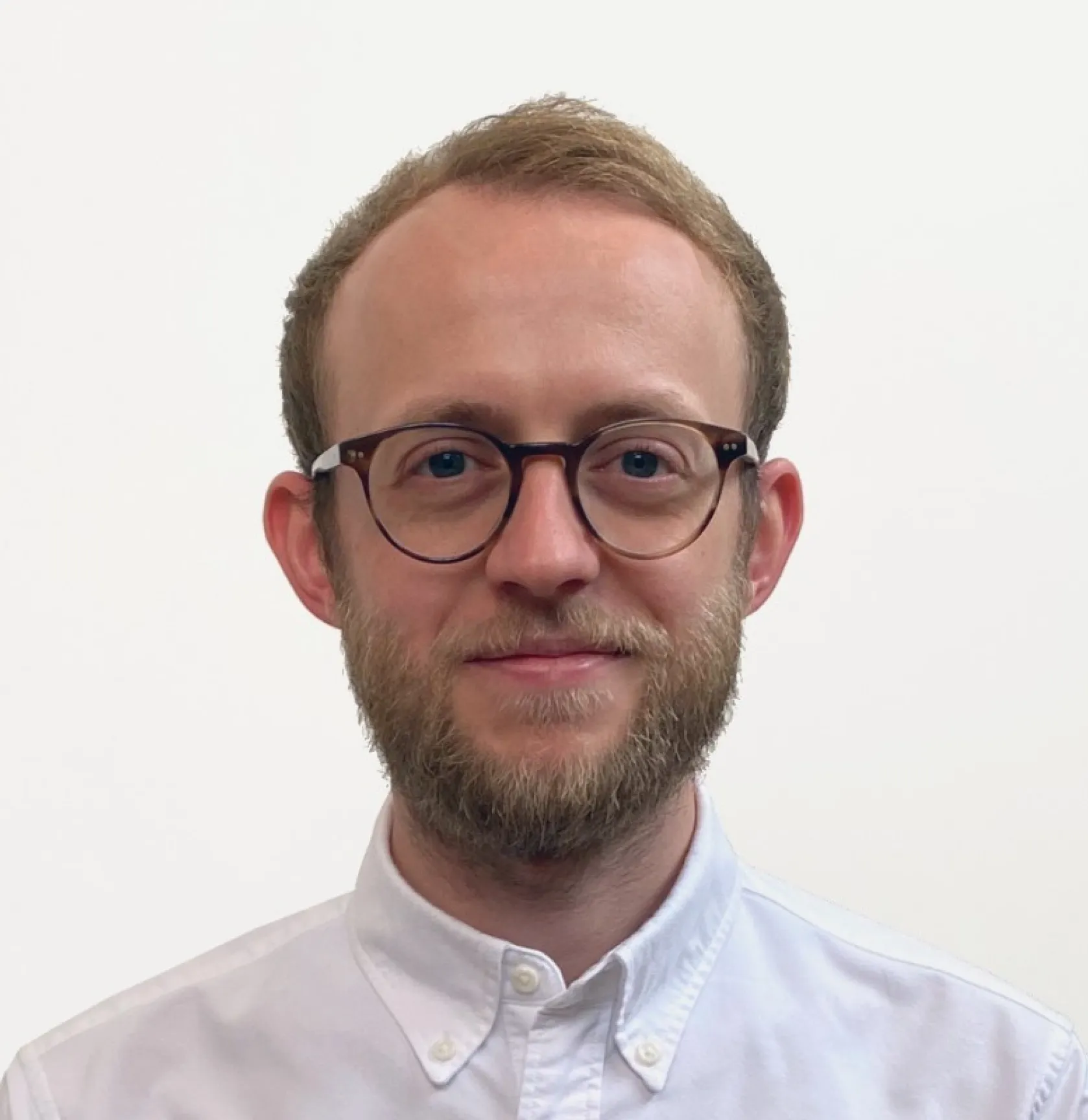 A man wearing glasses and a white shirt