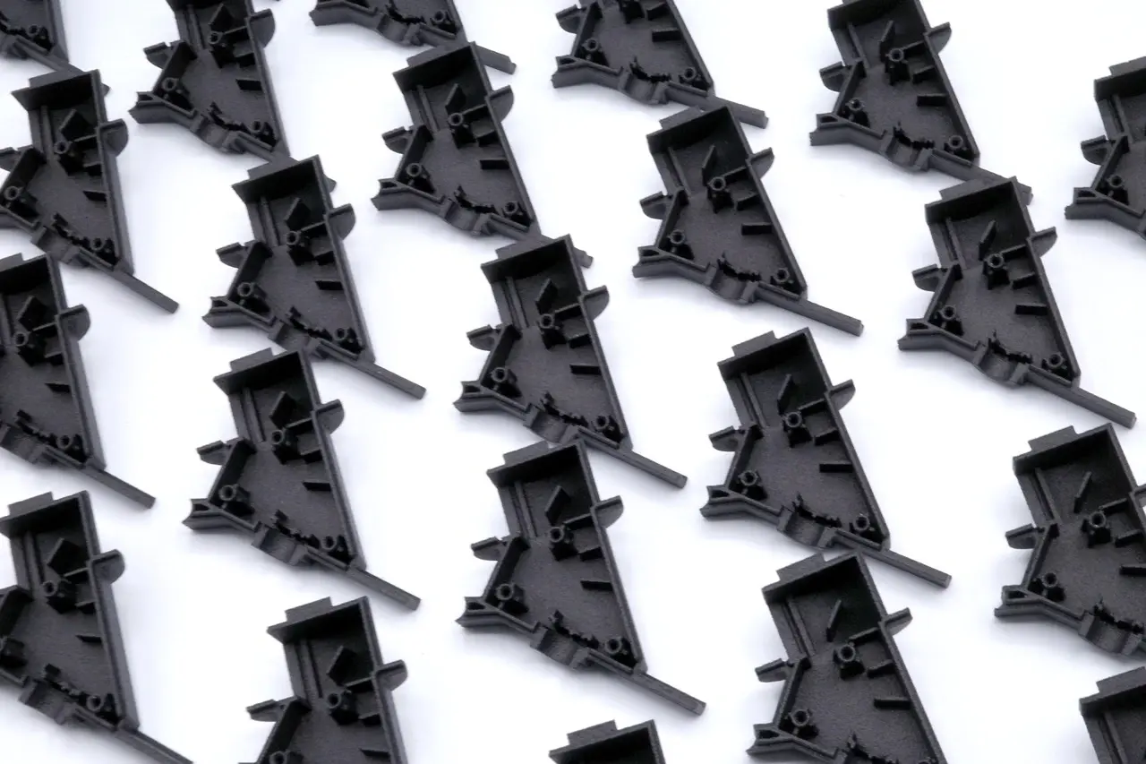 A bunch of black plastic pieces on a white surface