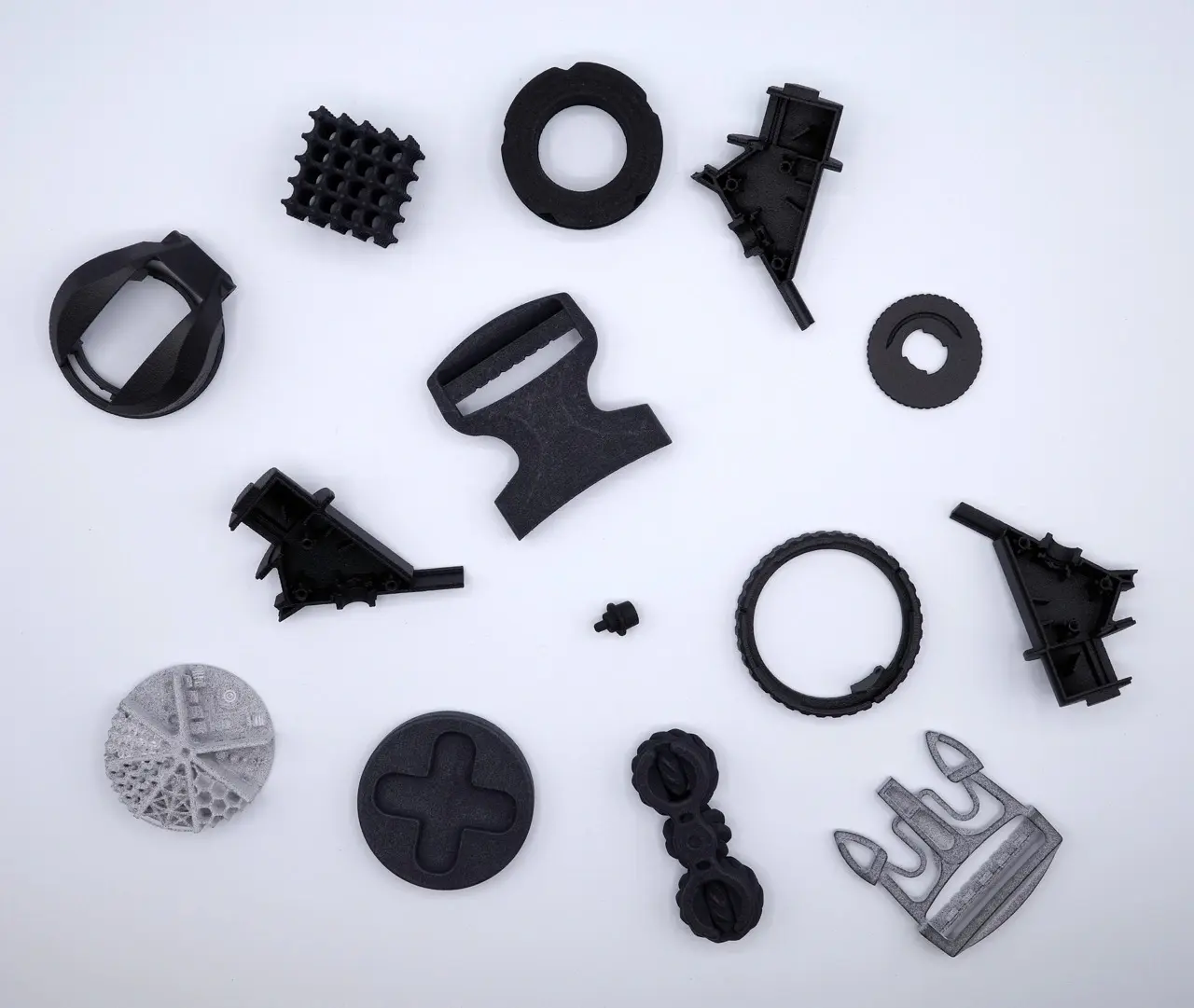 A collection of black plastic objects on a white surface