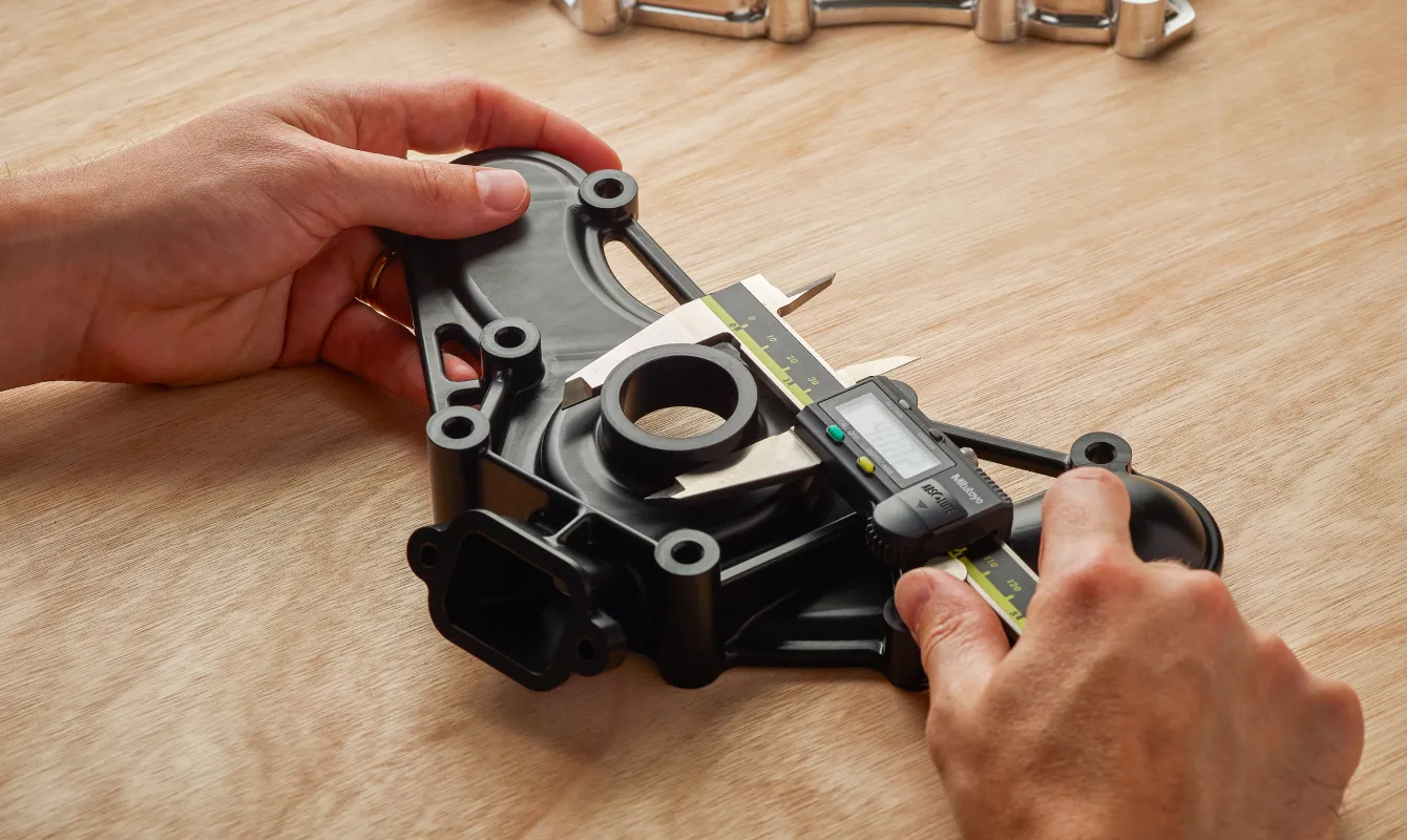 hands measuring plastic part