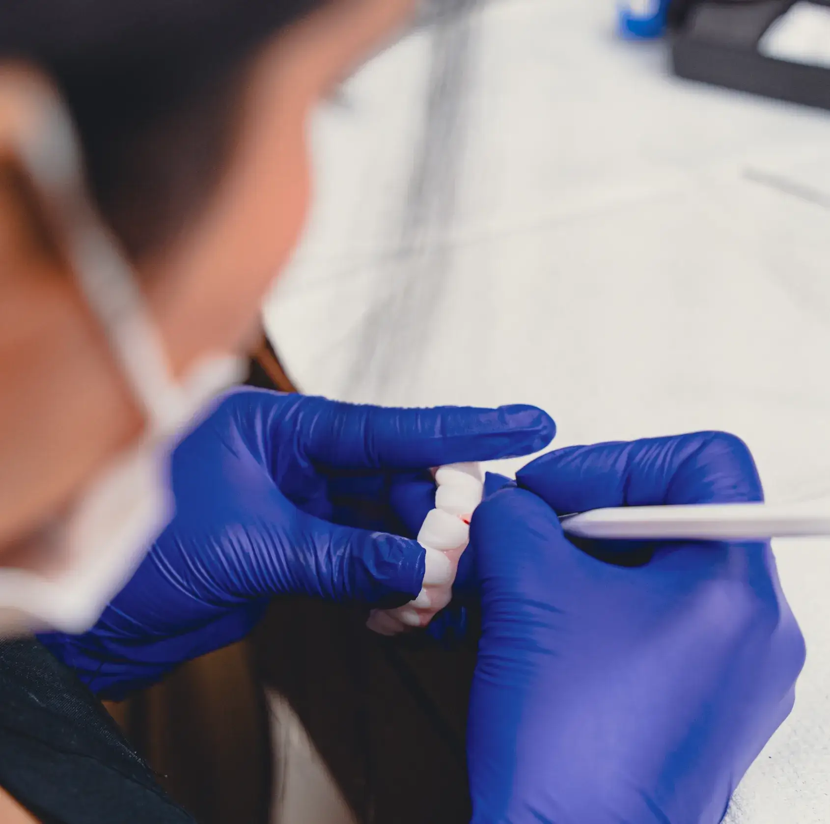 Technician holding denture