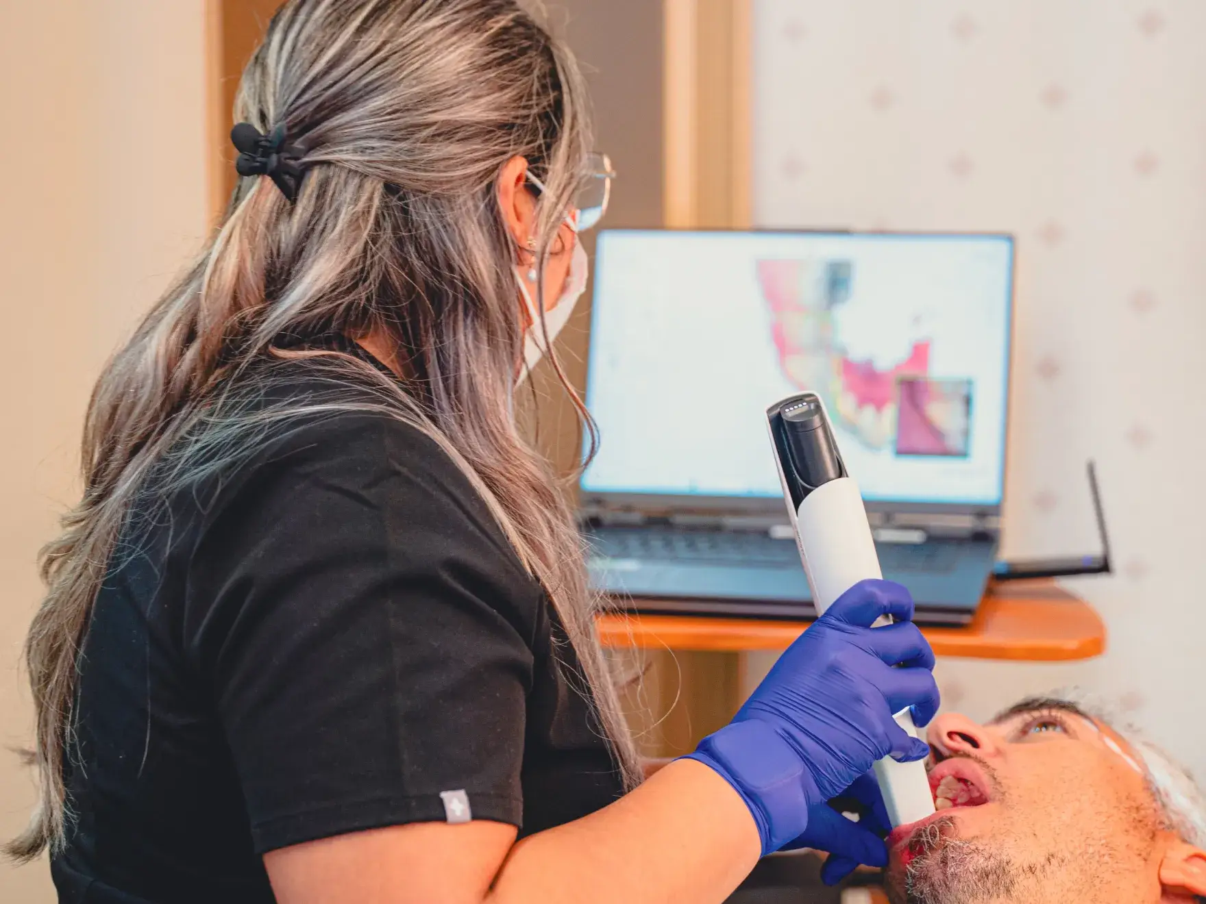 Grace Dental Care team member checking patient.