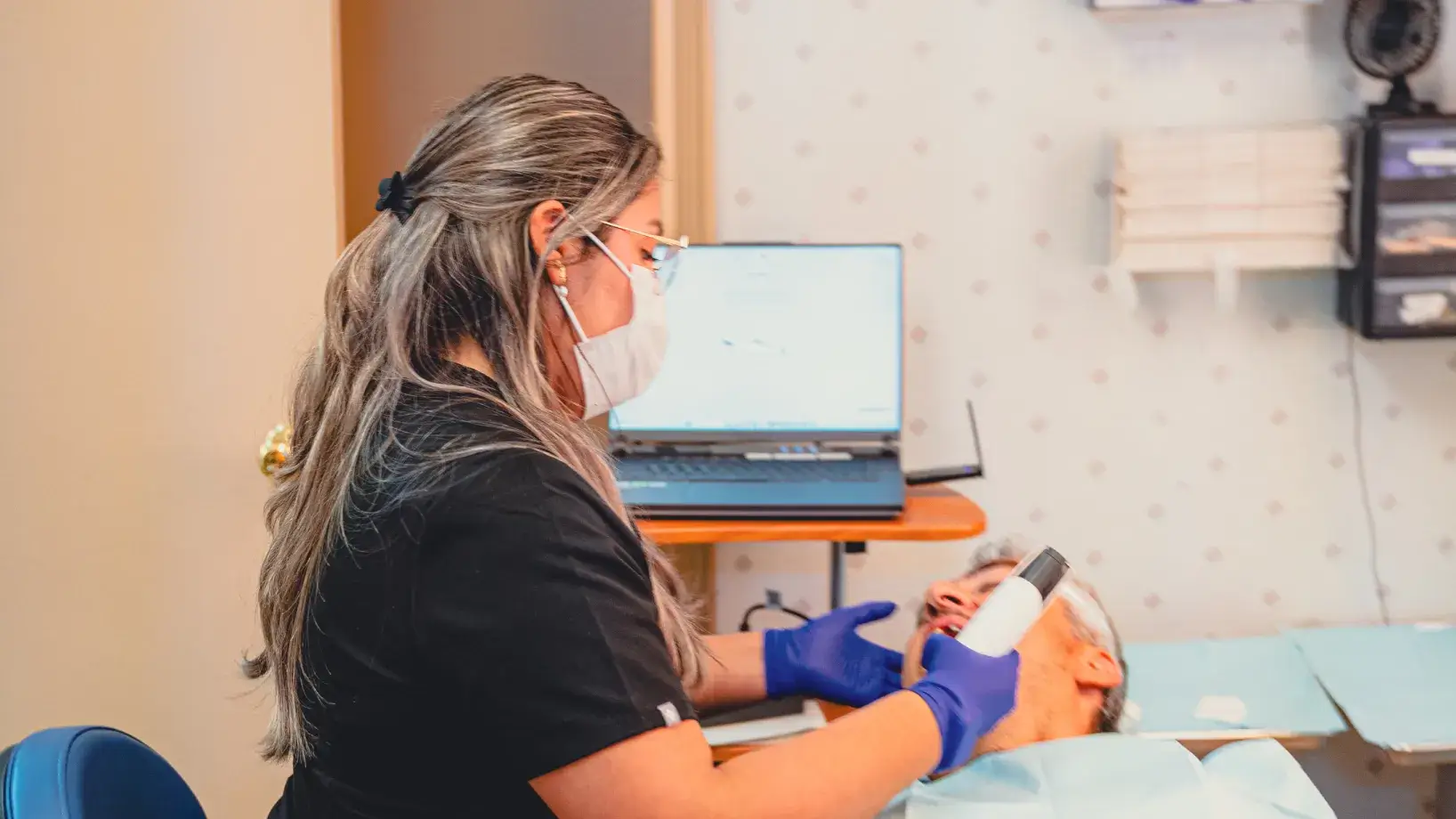 Grace Dental Care team member checking patient.