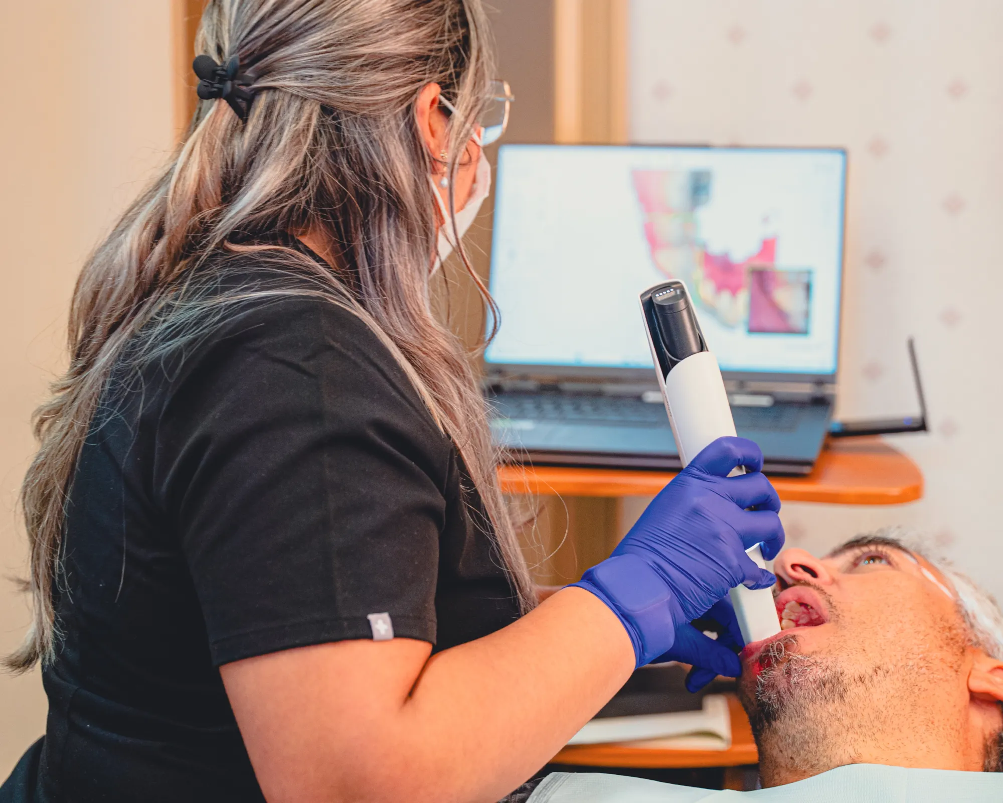 Grace Dental Care team member checking patient.