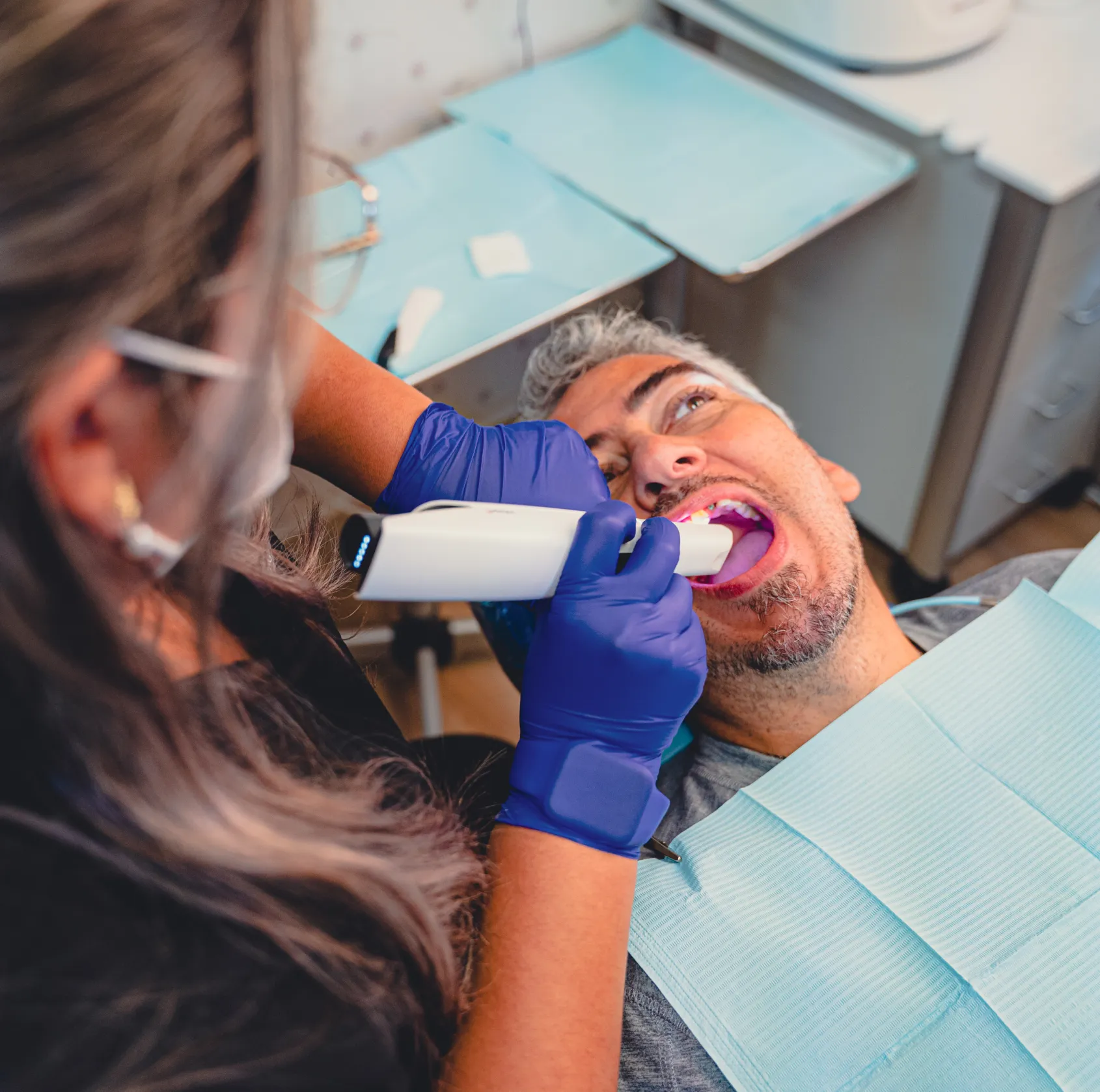 Grace Dental Care team member checking patient.