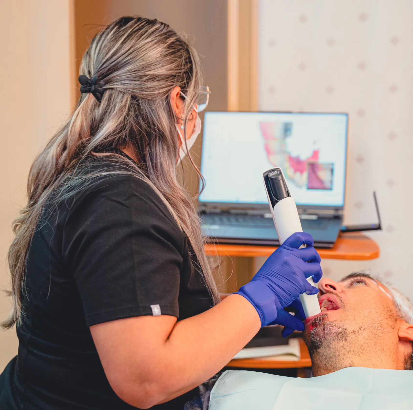 Grace Dental Care team member checking patient.