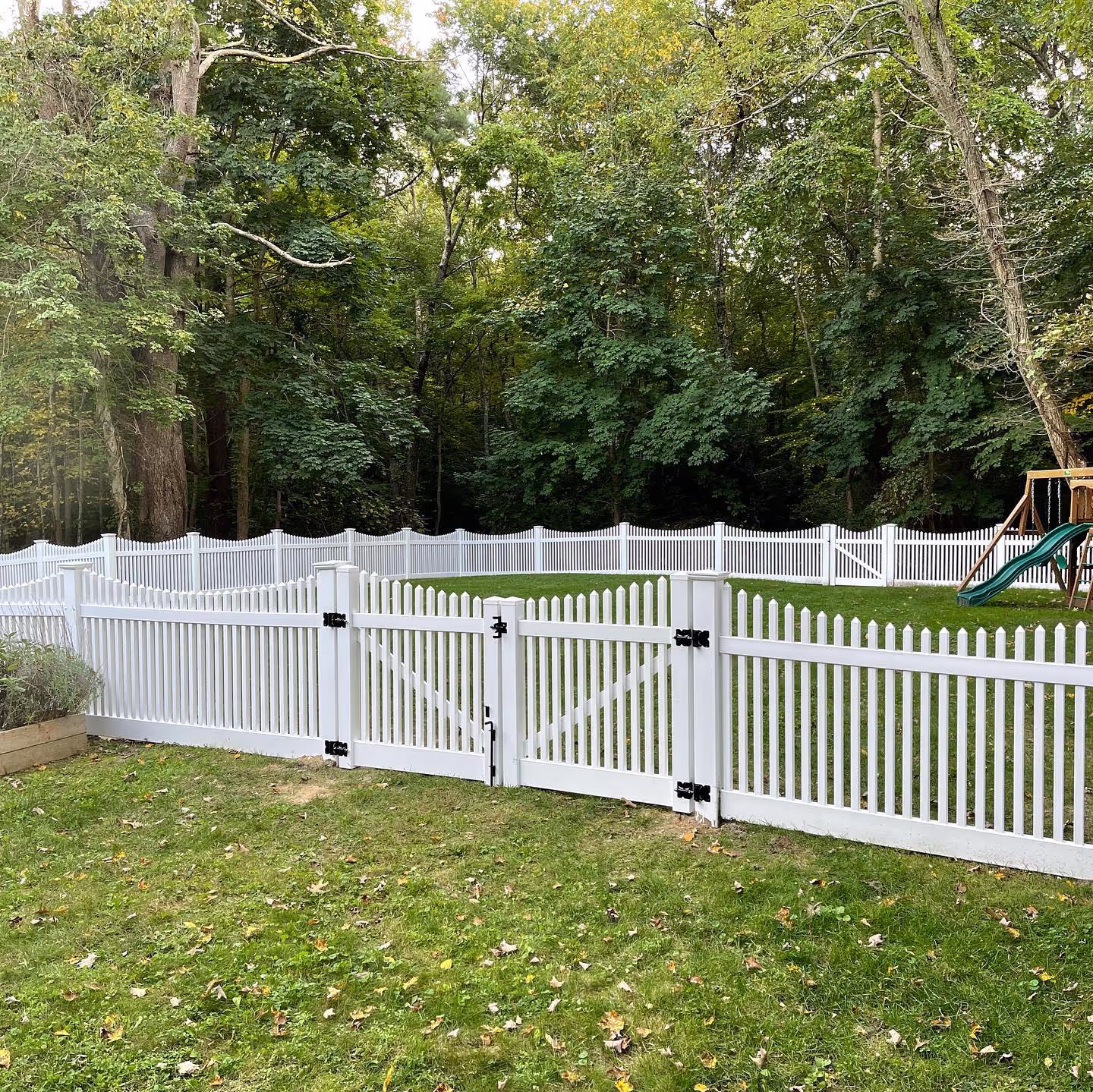 Corner aluminum fence enclosing yard