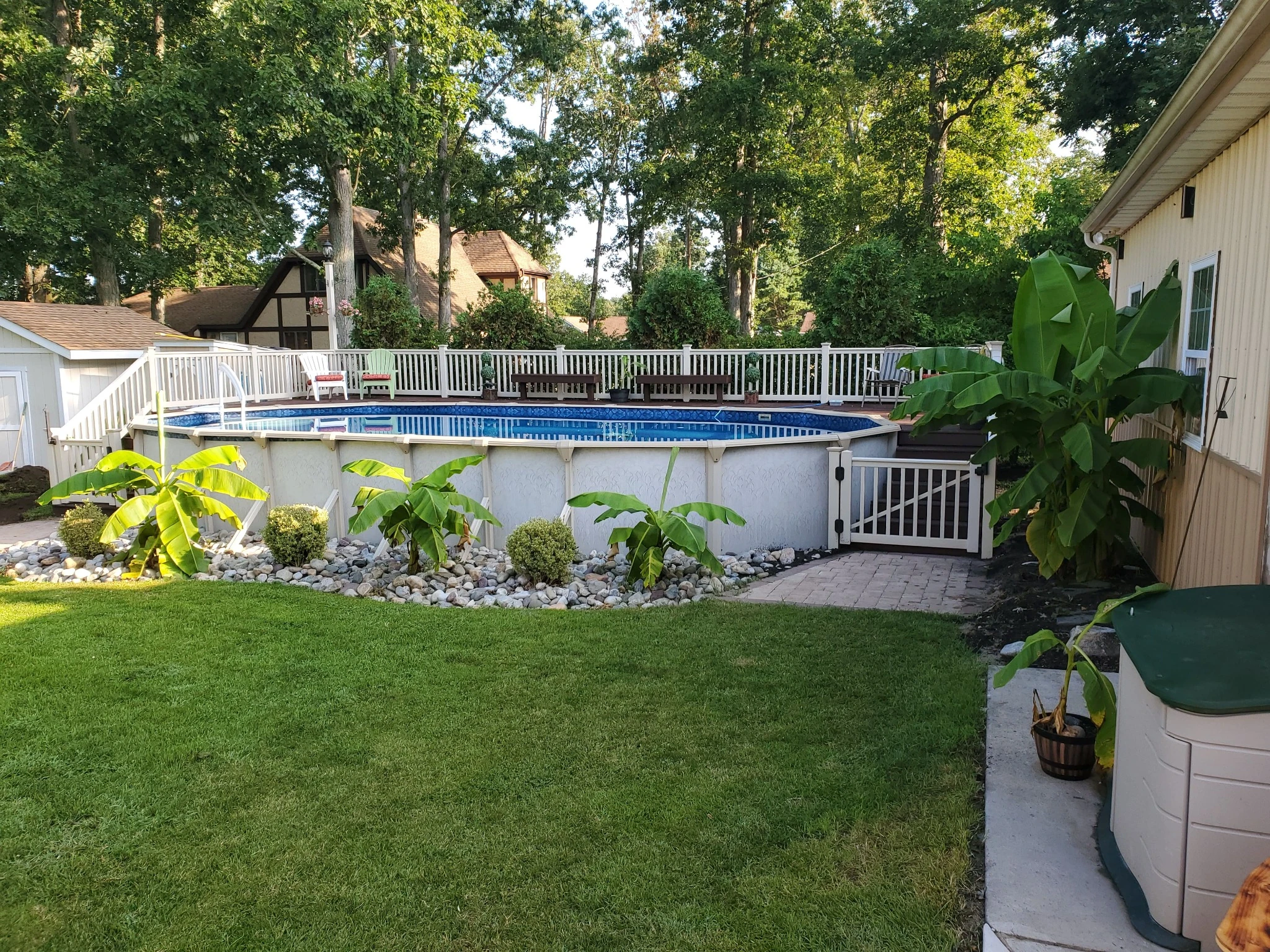 Backyard pool deck with white railings showing a completed project built with proper planning and permit approval.