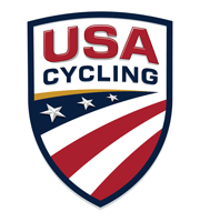 USA Cycling shield logo with red, white, and blue design featuring stars and stripes.