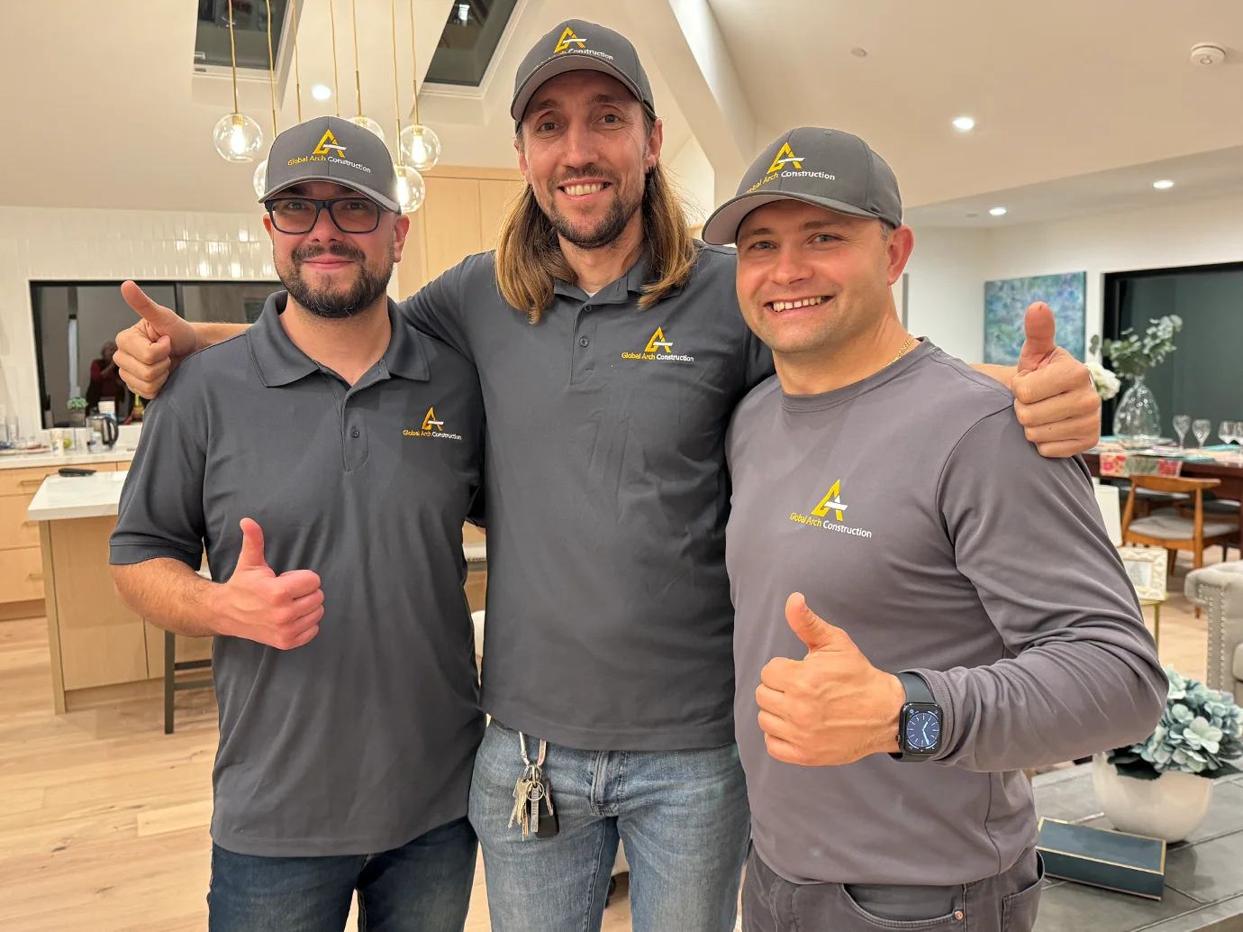 Global Arch Construction team members cheering after a successfull project completion.