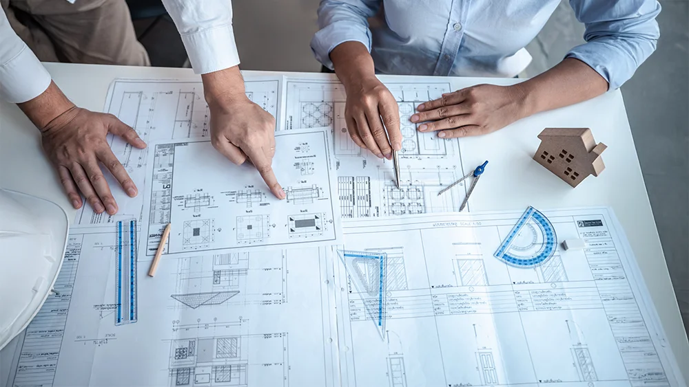 Architect and client reviewing floor plans.