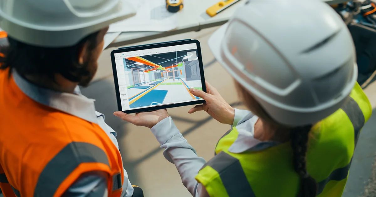 Client and worker reviewing a design of a commercial building.