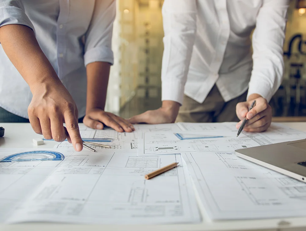 Two people review a construction project timeline.