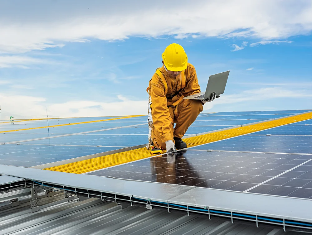 A worker is working on a commercial solar panel. 