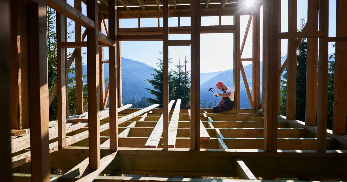 A worker working on a construction site of a home.