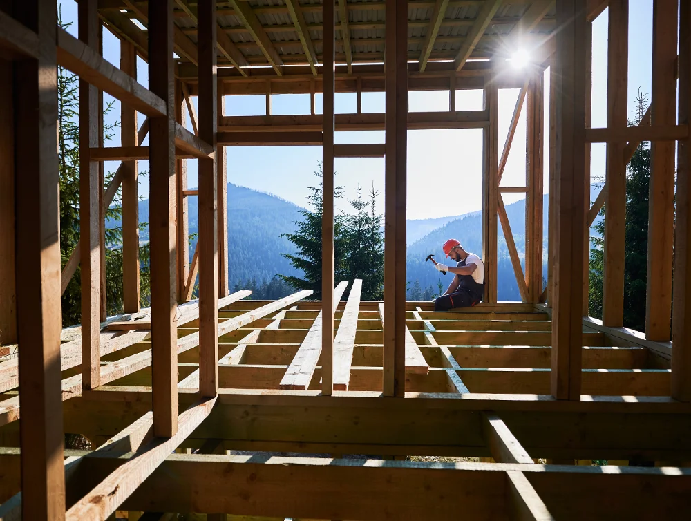 A worker working on a construction site of a home.