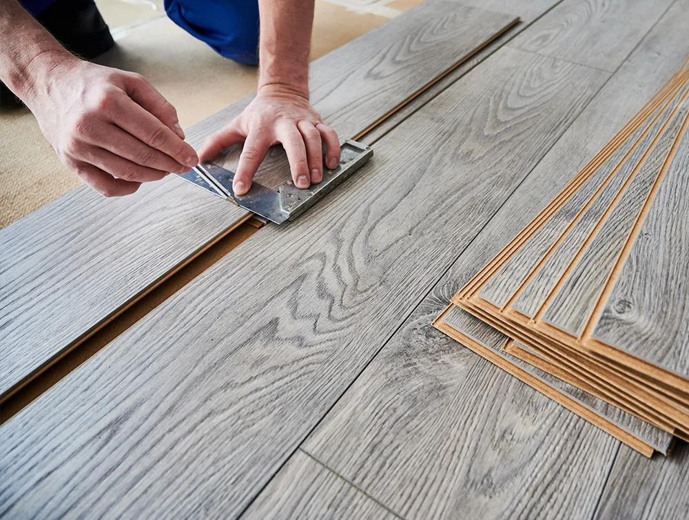 A man instaliing flooring.