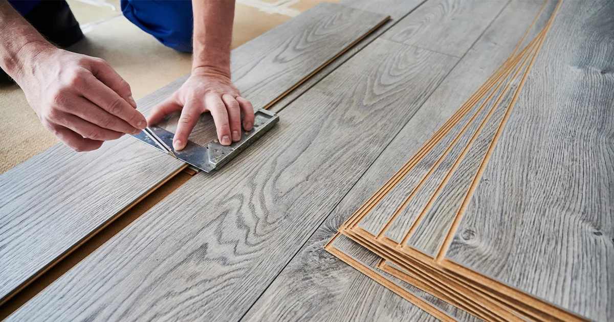 A man instaliing flooring.