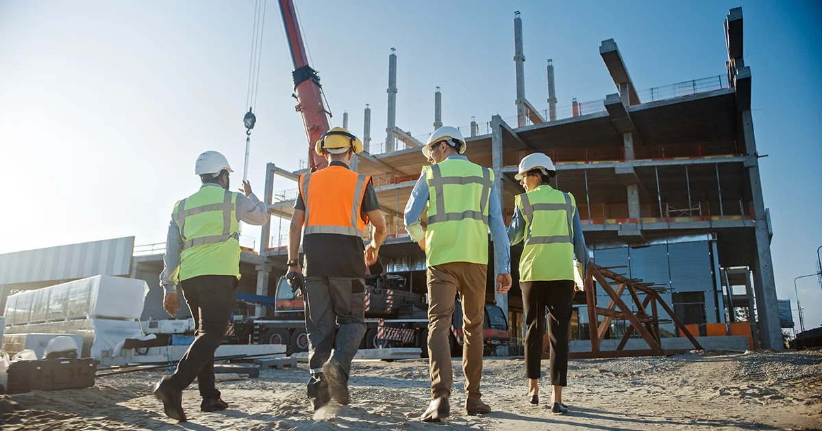 Construction workers inspecting a construction site.