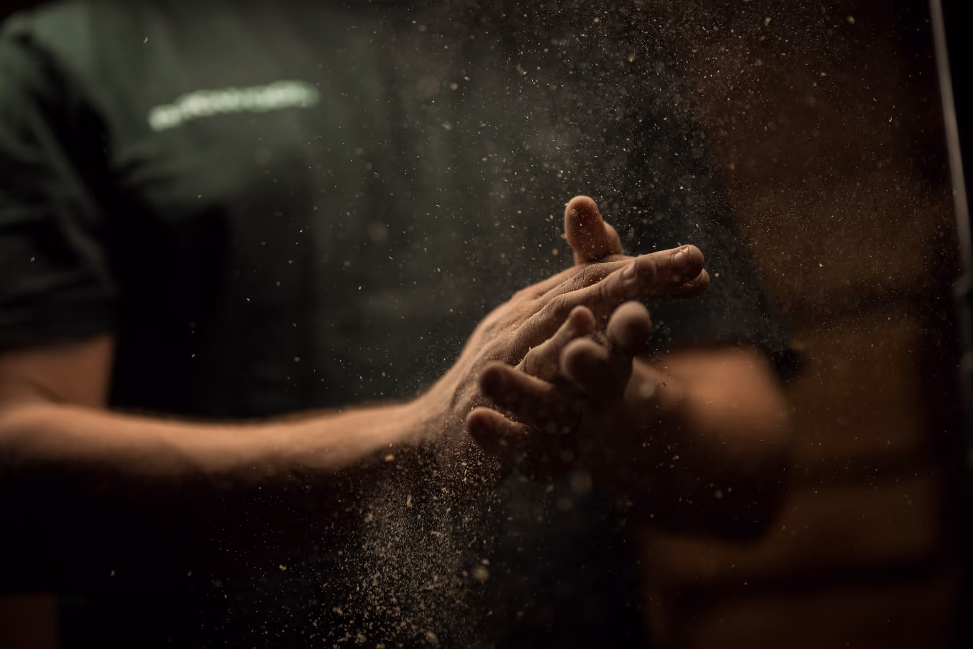 Person rubbing sawdust off hands