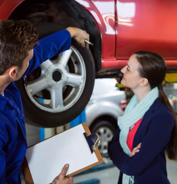 Smiling employees changing a tire