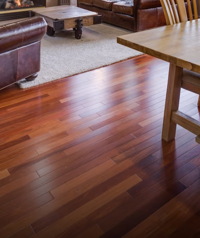 Rich-toned wood flooring in a furnished living room