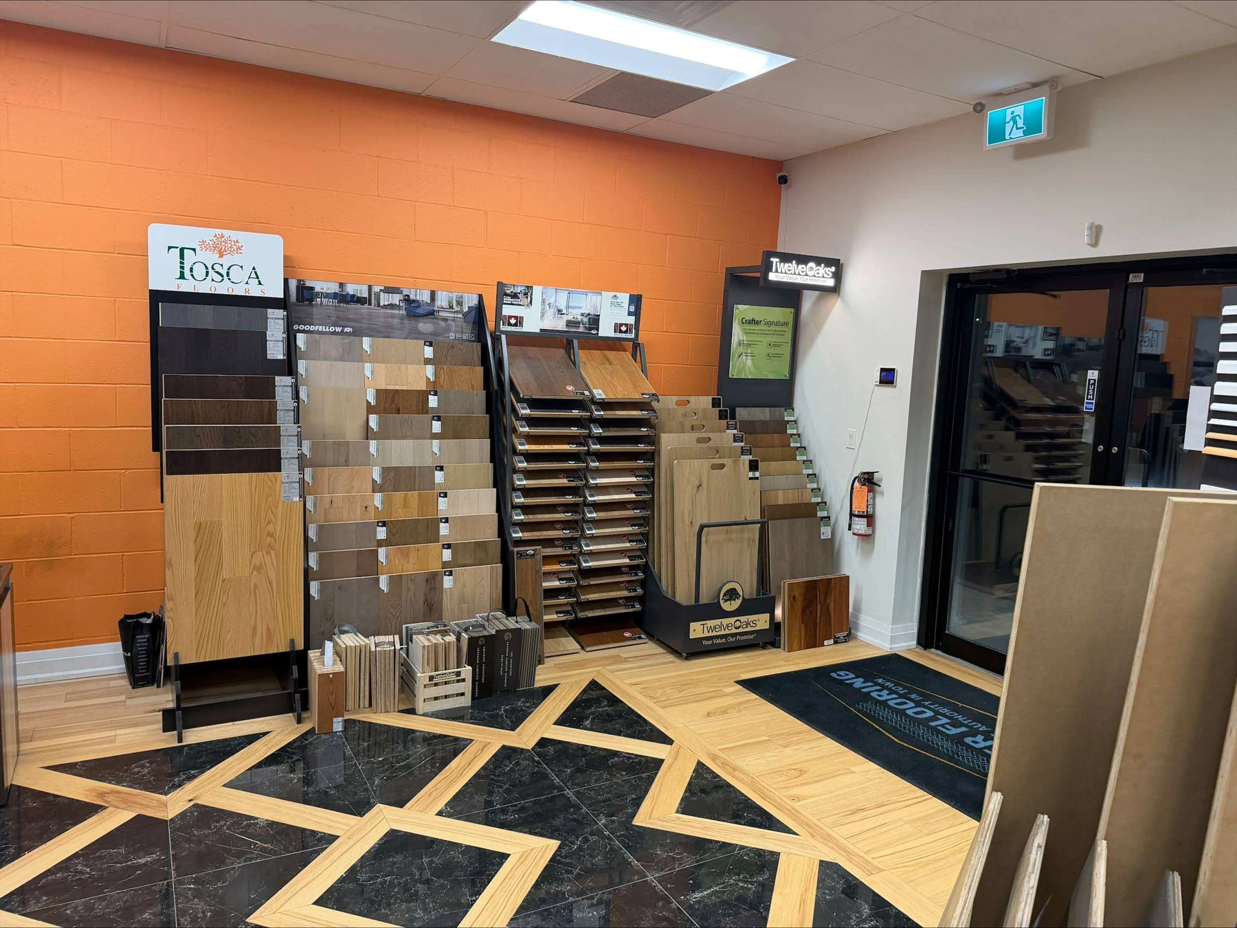 Flooring displays and patterned floor near the Master Flooring showroom entrance