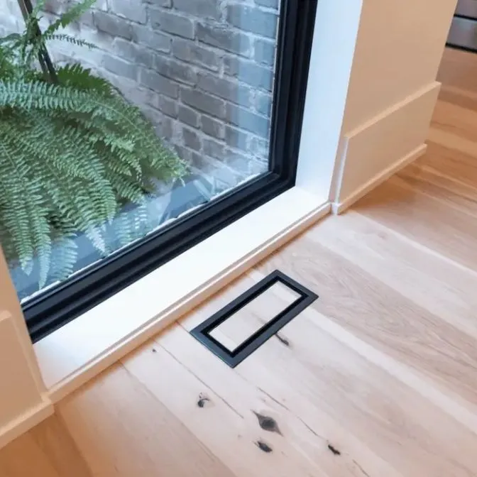 Floor vent style example with a dark frame and a matching hardwood insert