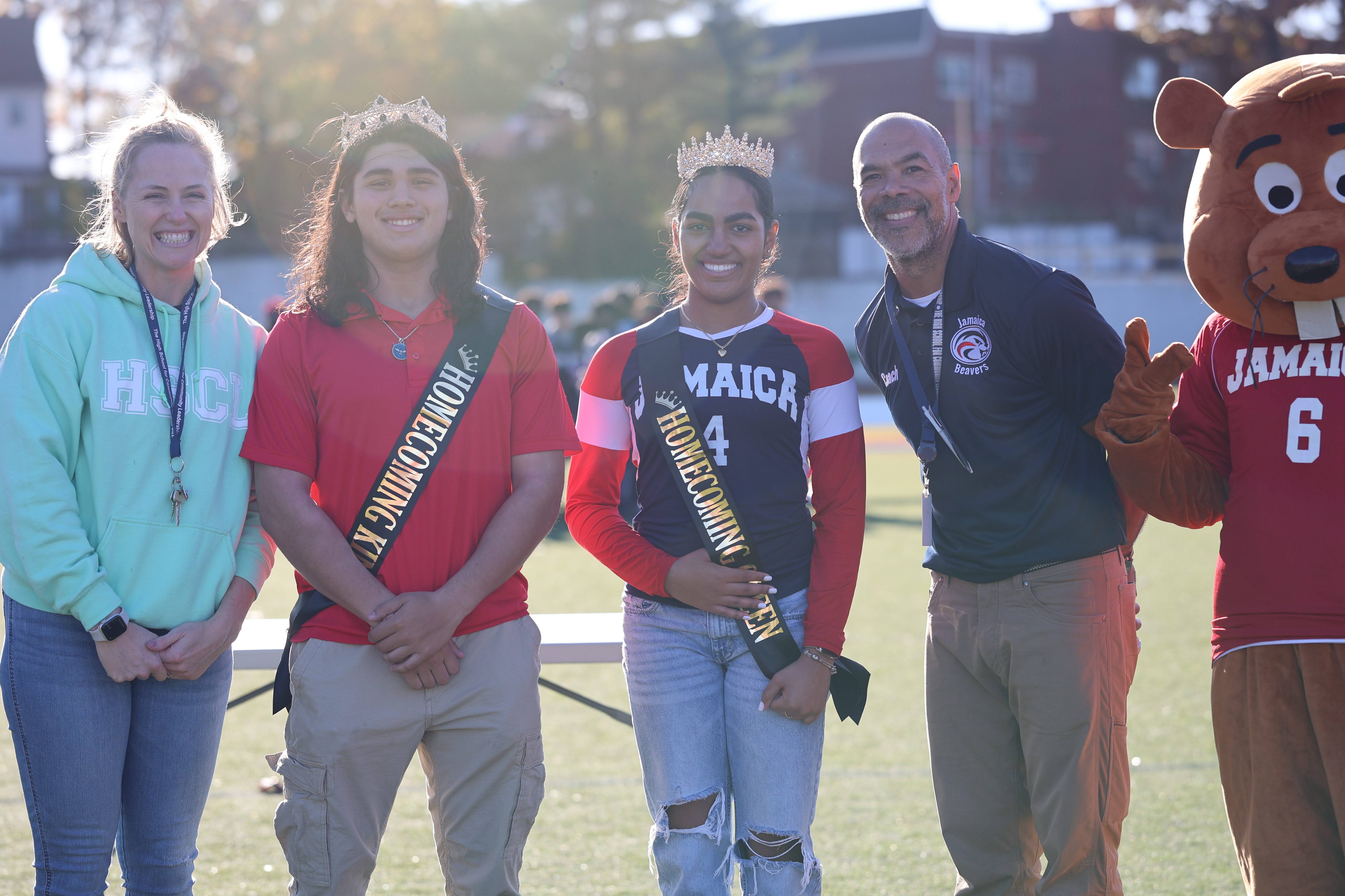 Jamaica High School homecoming king and queen crowned on field with mascot