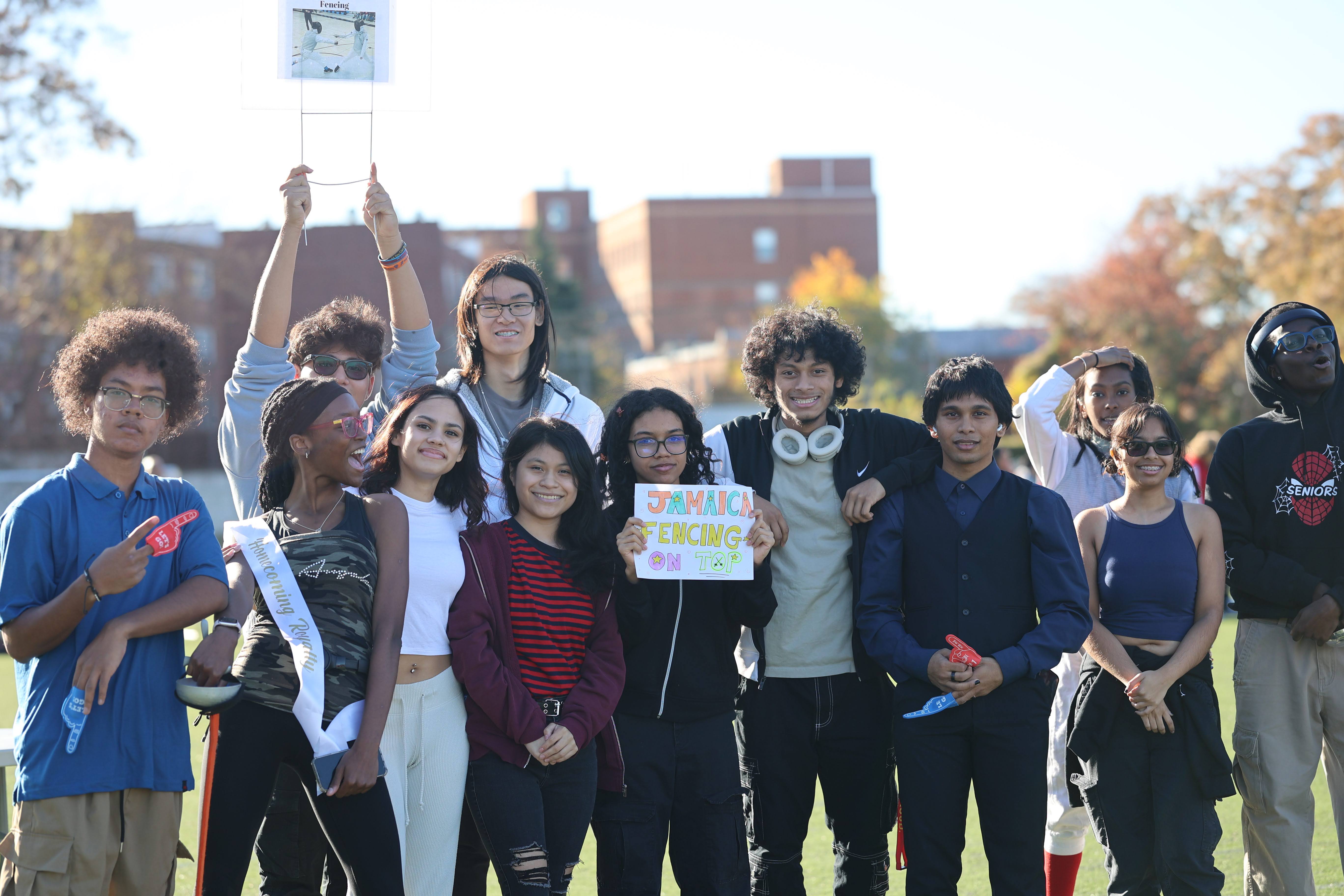 Students cheering at Jamaica High School fencing team outdoor event