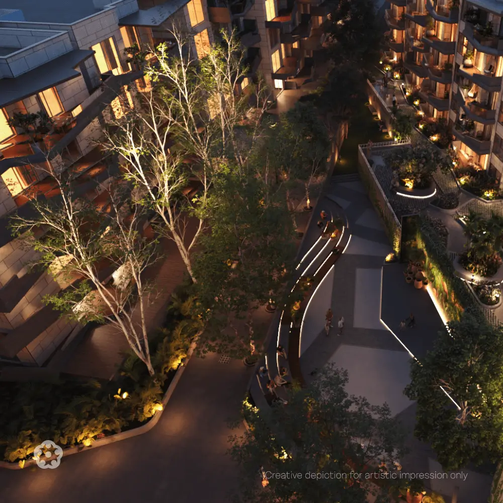 Nature-centric luxury apartment community with landscaped greenery, mature trees, walking pathways and illuminated outdoor spaces at night.